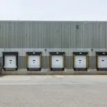 Industrial building exterior with several docking doors